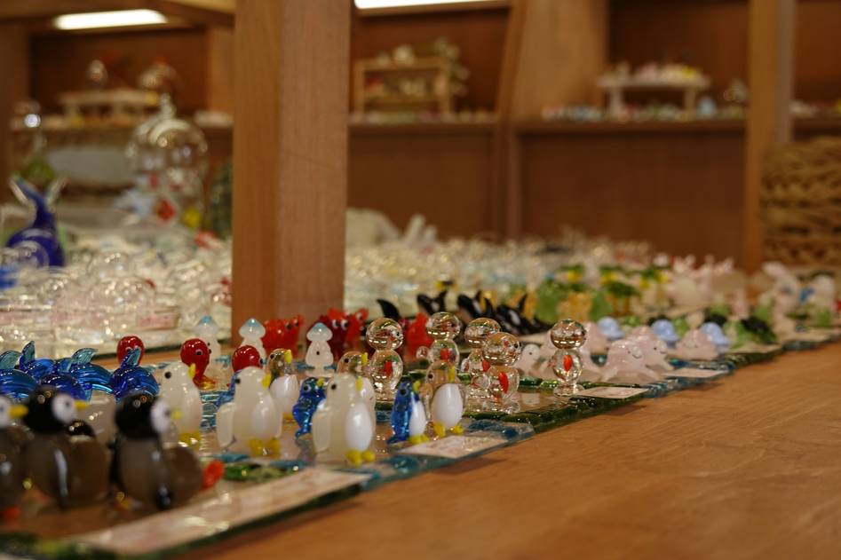 Elegant handcrafted glass pet toys arranged on a soft neutral surface